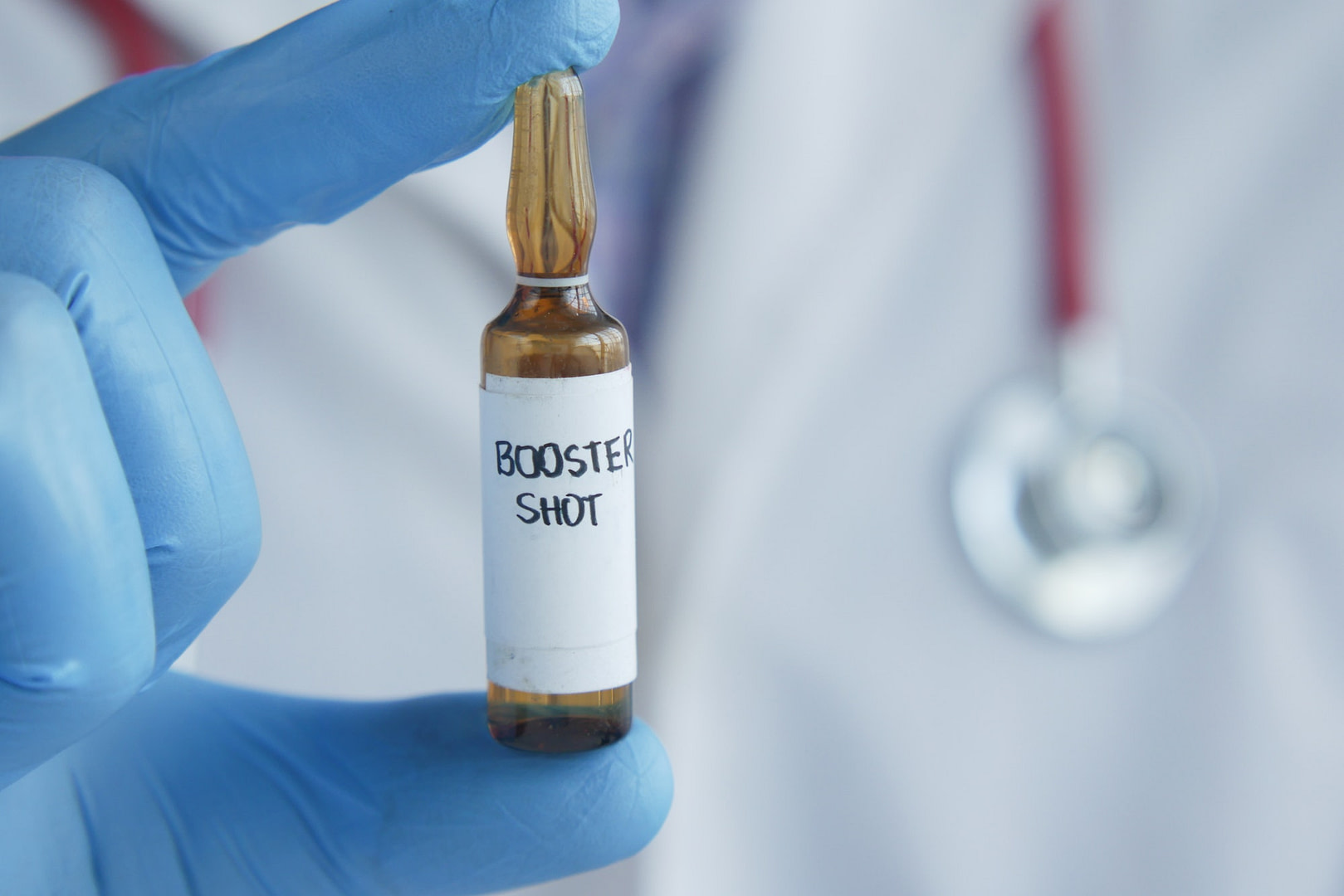 doctor hand hold booster shot dose coronavirus vaccine