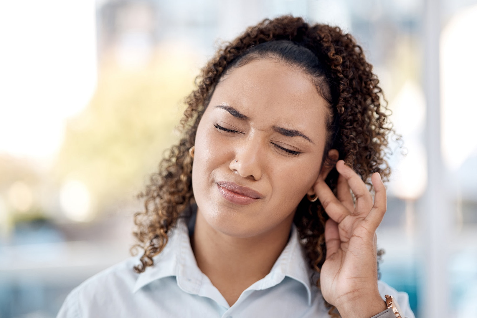 Earache, injury and woman with a hearing problem from noice, loud music and deaf. Stress, pain and