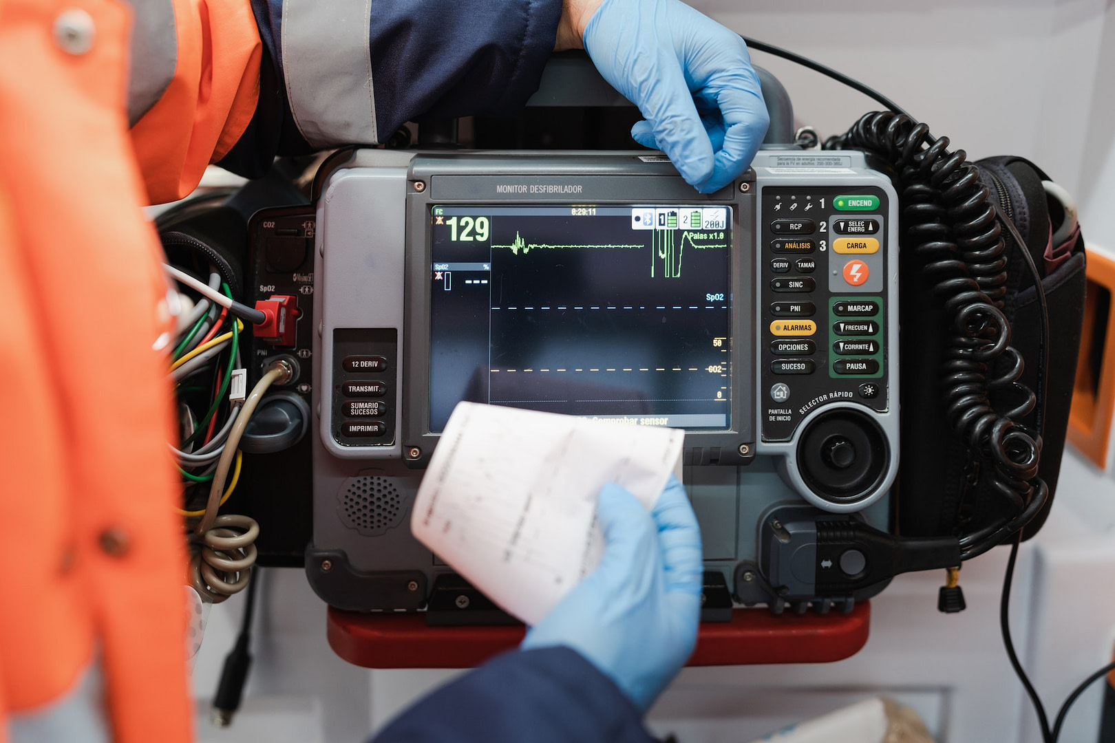 Close-up of a unrecognizable doctor using a defibrillator monitor
