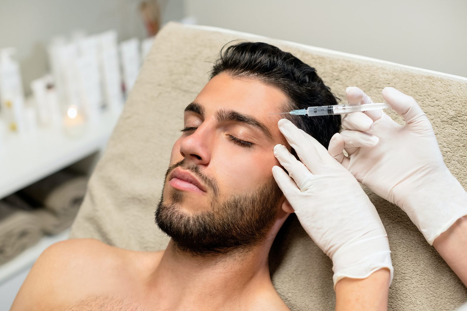 Young man receiving botox injection